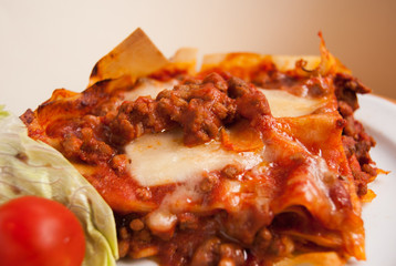 Close-up of lasagne with layers of minced meat and grated cheese
