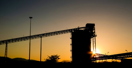 Silhouette of a mining silo and conveyor belts © Sunshine Seeds