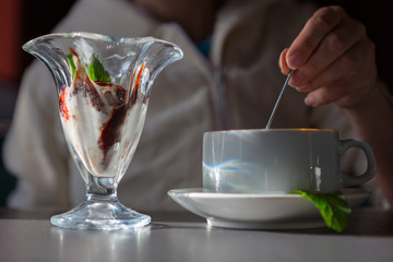 woman drinking coffee with ice cream in a cafe