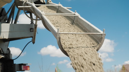 Cement on the troughs follows from the concrete mixer. Delivery of ready-made high-quality concrete concept