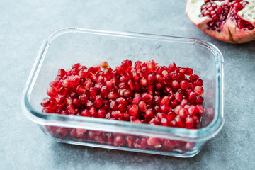 Ripe Pomegranate with Seeds in Glass Bowl.