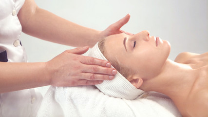 Young attractive woman getting spa treatment over white background.