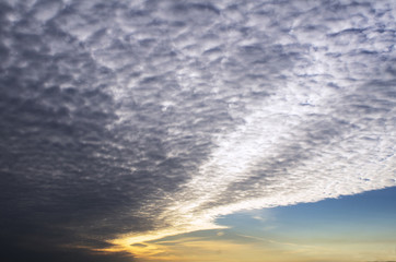In the evening sky in the rays of the setting sun beautifully spread like a fan cirrus cloud.