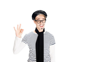 cheerful man in black beret showing ok sign isolated on white