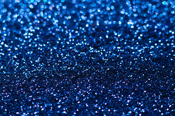 Blue glitter texture. Festive sparkling sequins background closeup. Wpaper for Valentine, New Year or Christmas Holidays