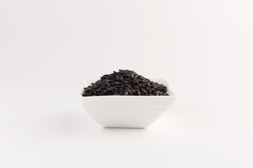Fototapeta na wymiar bowl of black wild rice isolated on white background