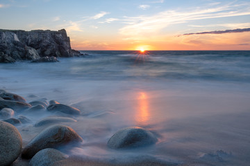 French landscape - Bretagne. A beautiful beach with wild cliffs in the background at sunset.