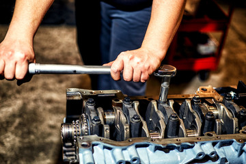 Automotive four-cylinder engine water cooling during repair.