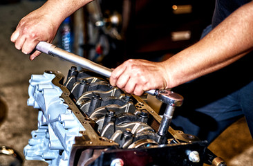 Automotive four-cylinder engine water cooling during repair.