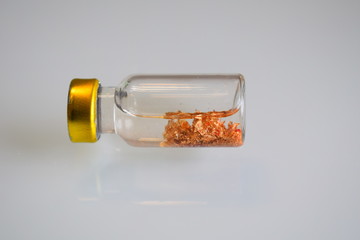 gold mineral harvested in a bottle and analyzed in the laboratory