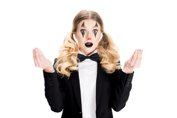 surprised female clown standing in suit and gesturing isolated on white