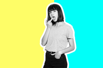 Collage in magazine young woman showing middle finger, impolite and rude fuck off expression...