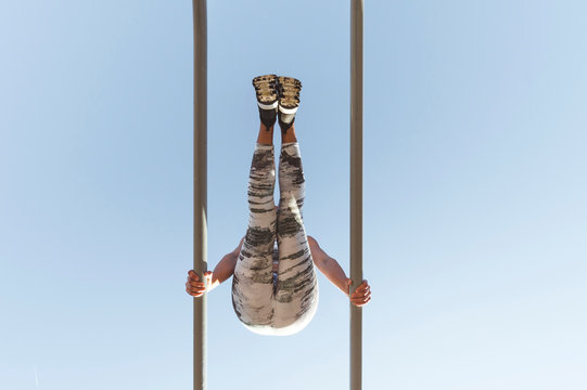 Woman training on parallel bars