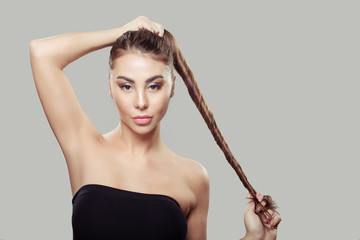 beautiful woman holding straight shiny strong hair