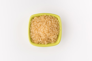 white rice in bowl isolated on white background, top view