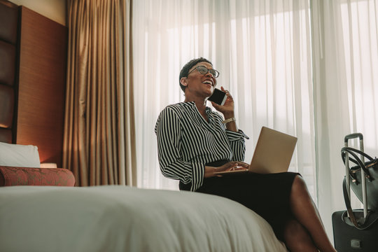 Woman CEO on business trip working from hotel room