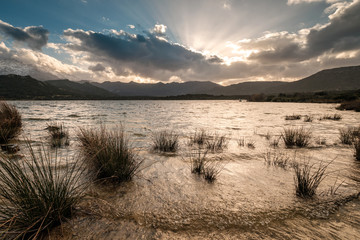 Sunset over Lac de Codole and mountains in Corsica