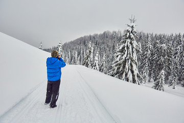 Professional photographer in the winter landscape