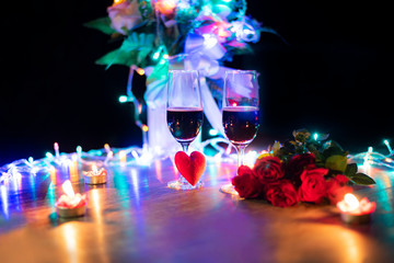 Valentines dinner romantic love concept / Romantic table setting decorated with red heart and couple champagne glass