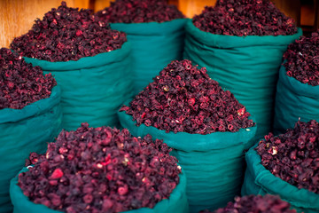 Dry herb hibiscus in baskets. Arabic herbs on traditional bazaar. Natural organic food.
