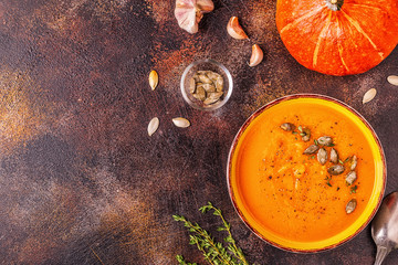 Pumpkin and carrot soup served with seeds.