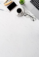 Stylized marble office working desk with smartphone, laptop, glasses and coffee, workspace design,...