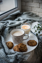 Cozy weekend breakfast with cup of coffee and cookies on ceramic tray