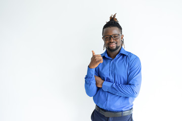 Fototapeta premium Happy black man showing thumb up and looking at camera. Young guy recommending something. Advertisement concept. Isolated front view on white background.