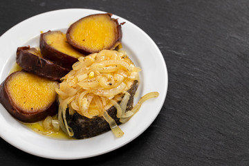boiled fish with onion and sweet potato on white dish