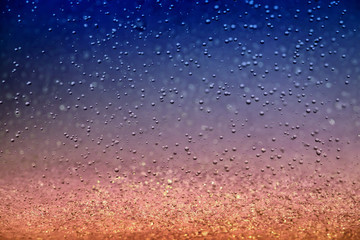Fototapeta na wymiar Splashes of raindrops on a colorful background