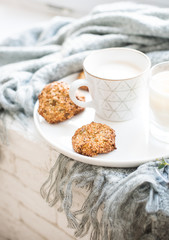 Cozy weekend breakfast with cup of coffee and cookies on ceramic tray