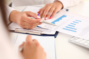 Businesswoman holding a silvery pen in her