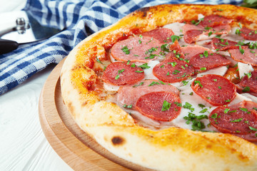 Close up view on pizza on white wooden background with ingridients.  Restaurant, food menu, recipe, cafe concept. Lifestyle food. Italian cuisine with free copy space. Menu photo. Italian fast food