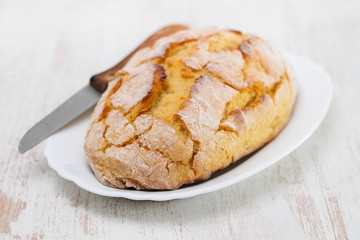 corn bread with knife on white dish
