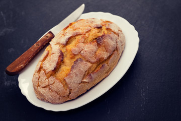 corn bread with knife on white dish