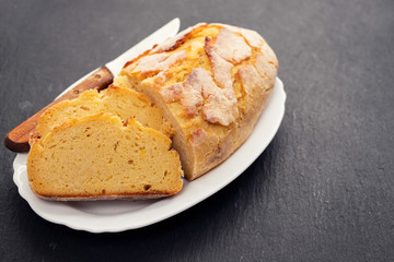 corn bread with knife on white dish