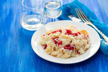 rice with cod fish and red pepper on white dish