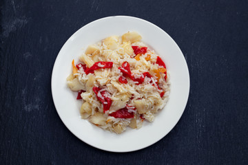 rice with cod fish and red pepper on white dish