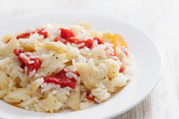 rice with cod fish and red pepper on white dish