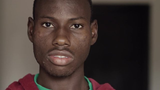young black african man opening his cosed eyes-indoor