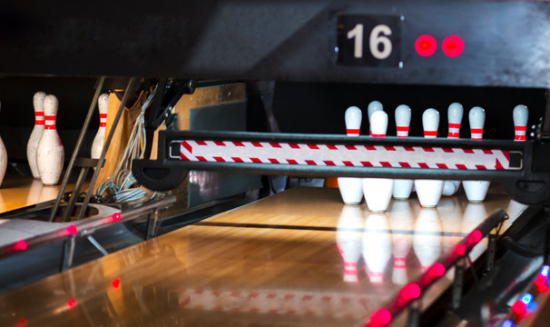 Close up of alley at bowling club. pin bowling alley background. Closeup of ten pin row on a lane, night light and sphere ball . Victory concept competition in a team action game
