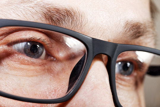 Closeup photo of human eyes with glasses. Shallow focus.