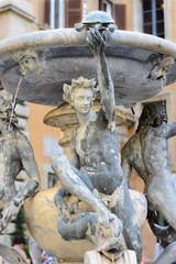 Fototapeta na wymiar Roman sculpture located in the fountain in Rome
