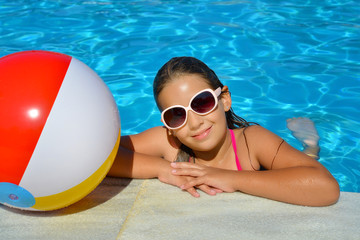 Real adorable girl relaxing in swimming pool