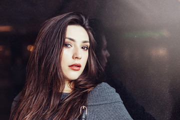 Close up portrait of brunette gorgeous beautiful girl on black background