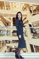 Young brunette girl in modern shopping center. Happiness, positive, fashion concept