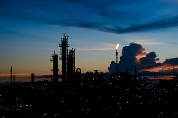 Fototapeta na wymiar silhouette factory with dramatic sky background,petrochemical plant area with beautify sky at sunset.