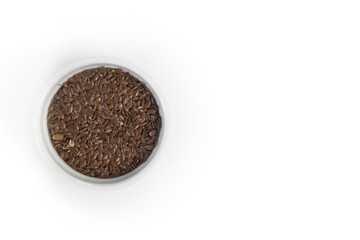 Flax seeds in white bowl on grey background, top view