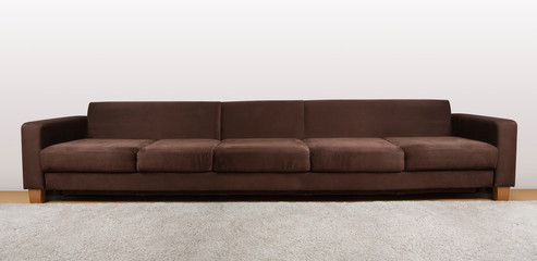 Large isolated cozy couch in brown color.