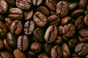 Aroma roasted coffee beans, brown background. Soft focus close up.